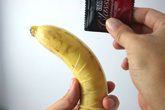 8:08 pm. someone holding a banana with a condom over it demonstrating usage...